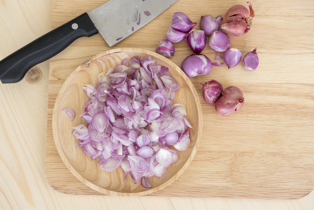 Sliced shallots in bowl