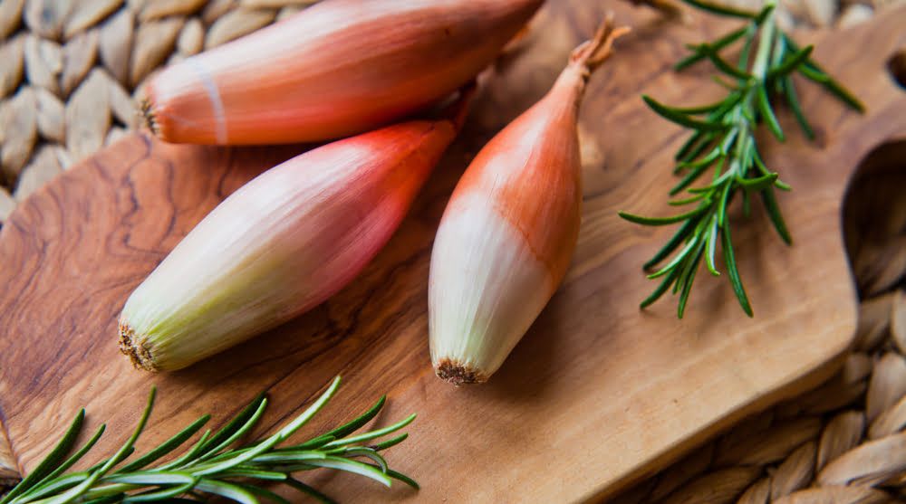 Shallots on chopping board