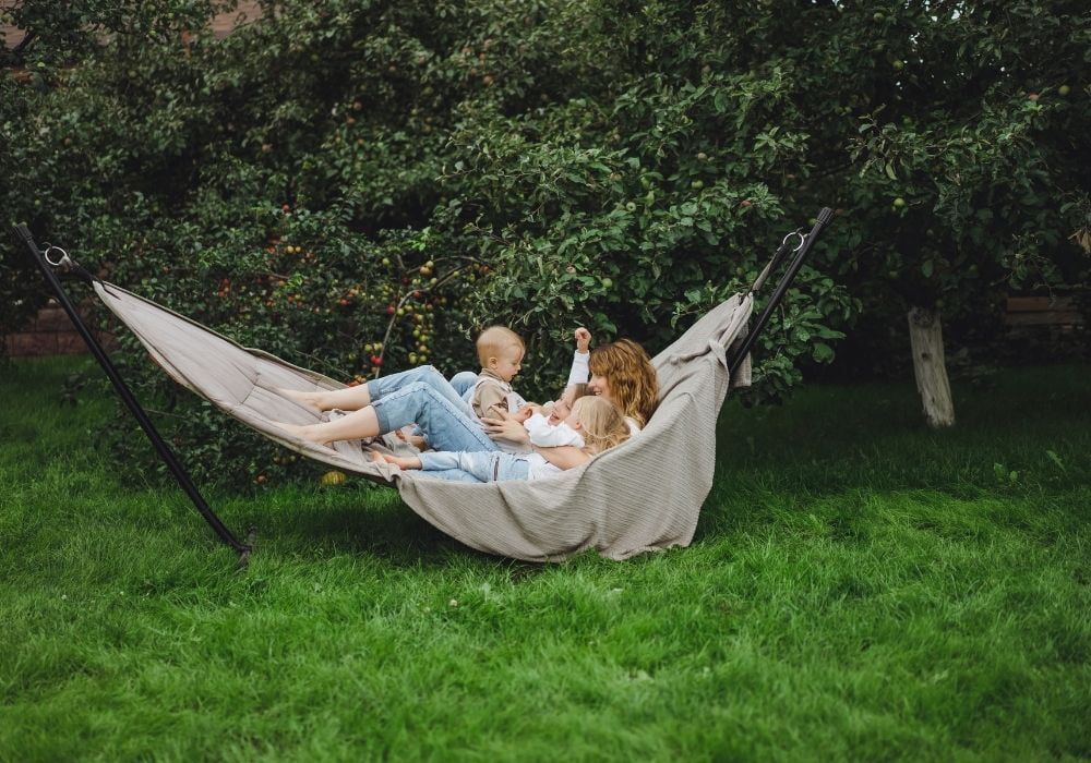 mum-and-kids-having-fun-in-a-hammock-in-garden