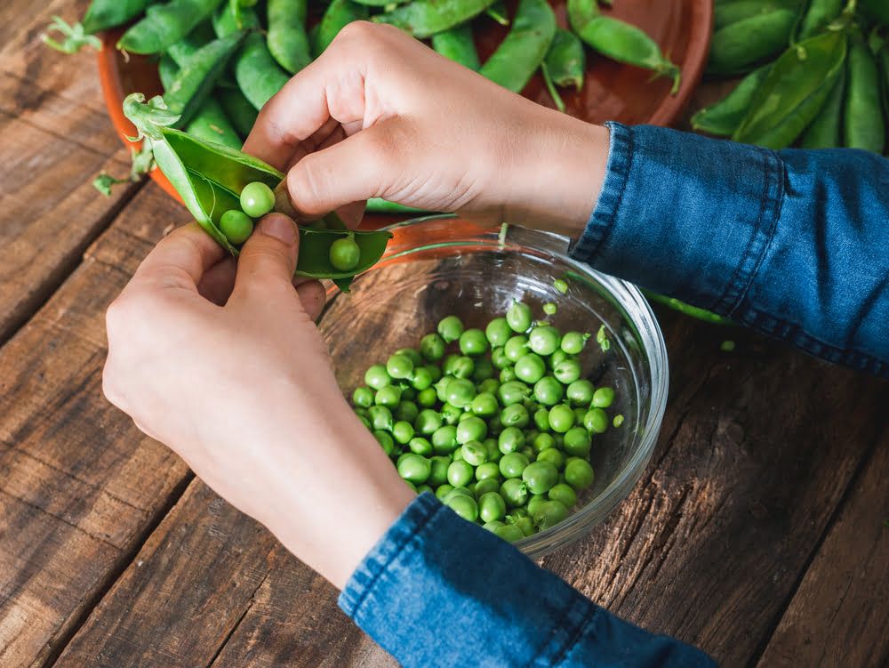 Person shelling peas