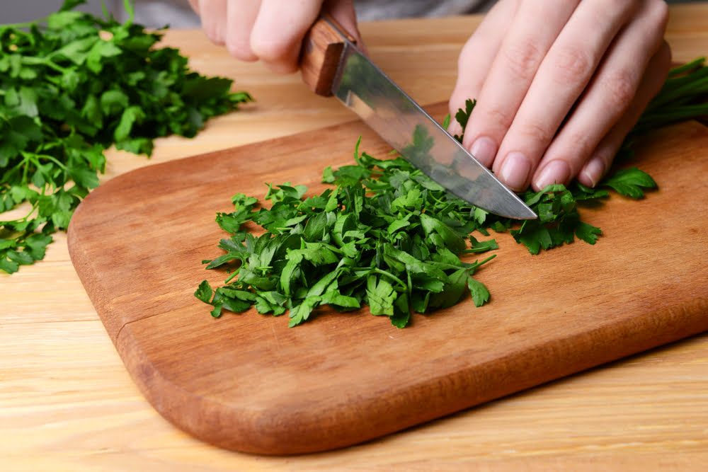 Chopped parsley on chopping board