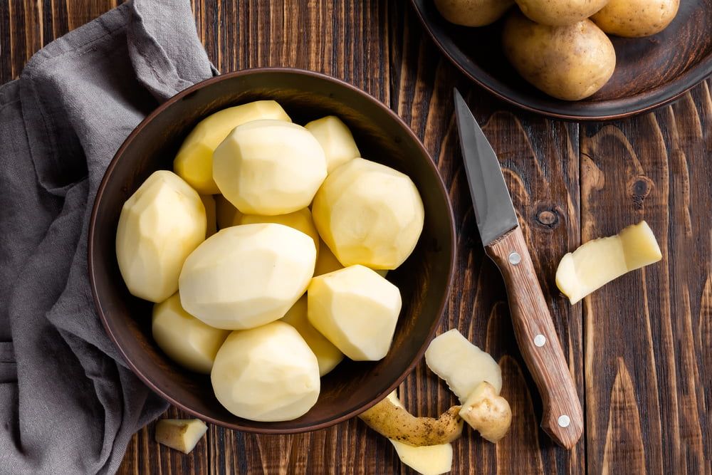 Peeled potatoes in bowl