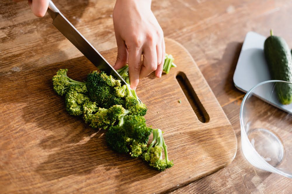 Hand chopping broccoli