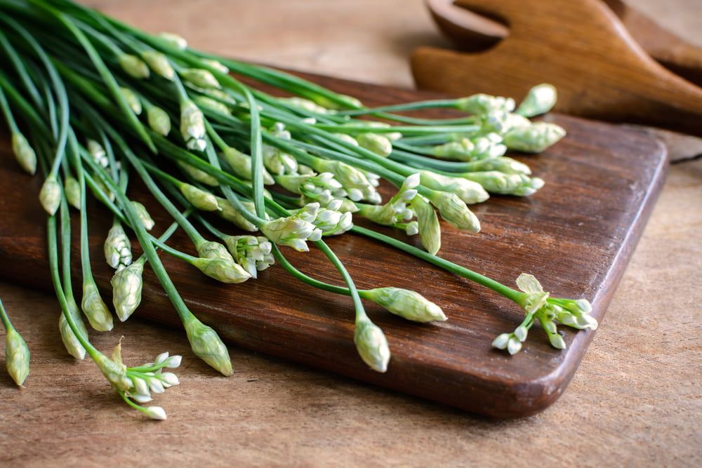 Garlic chives on chopping board