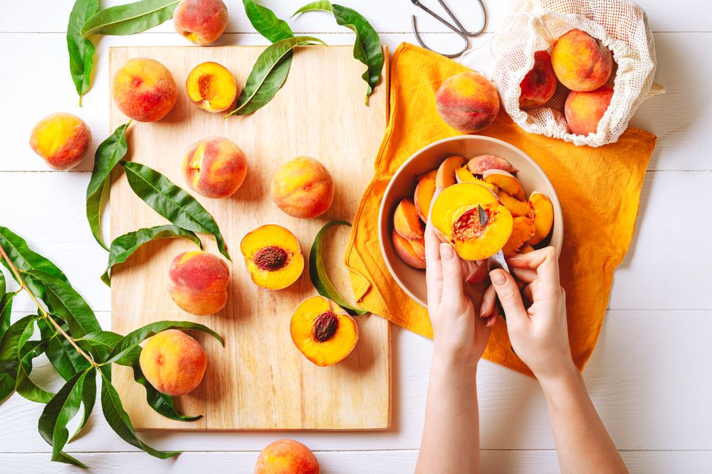 Woman slicing peaches